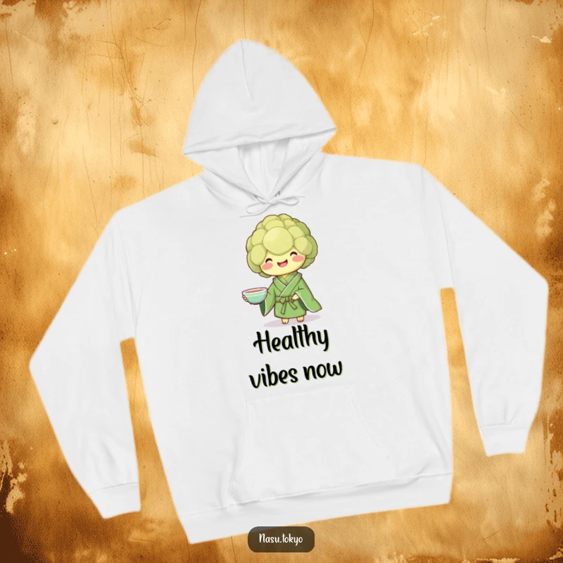 Funny broccoli in a green kimono holding a teacup, a warm and humorous hoodie for ultimate comfort.